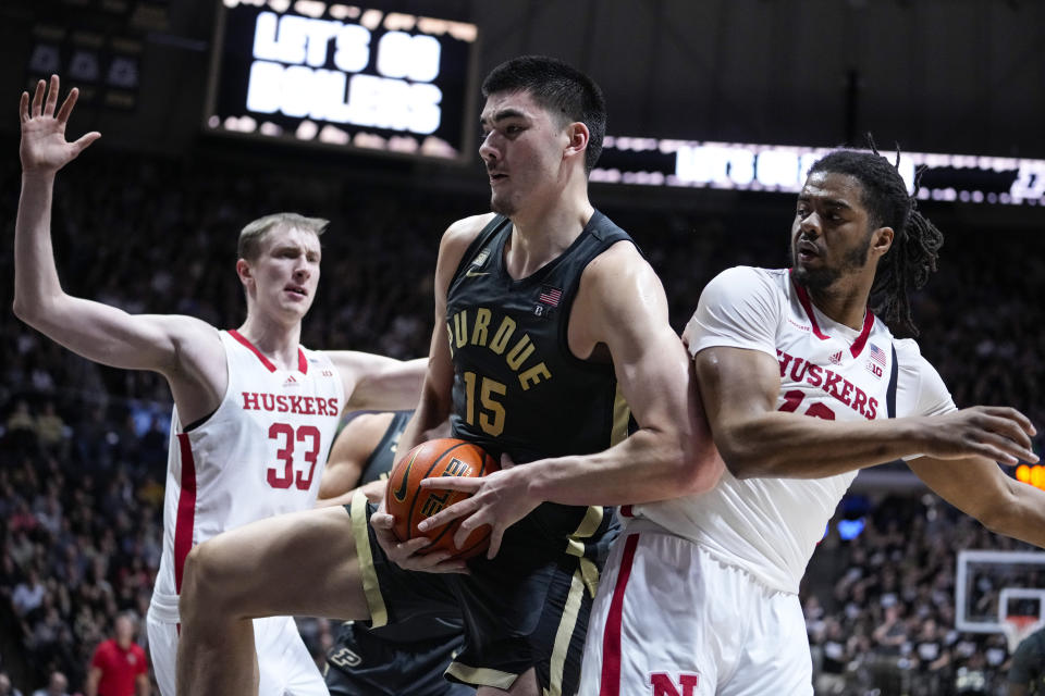 CORRECTS PLAYER AT LEFT TO OLEG KOJENETS, INSTEAD OF QUARAN MCPHERSON - Purdue center Zach Edey (15) grabs a rebound between Nebraska forward Oleg Kojenets (33) and forward Derrick Walker (13) during the second half of an NCAA college basketball game in West Lafayette, Ind., Friday, Jan. 13, 2023. Purdue defeated Nebraska 73-55. (AP Photo/Michael Conroy)