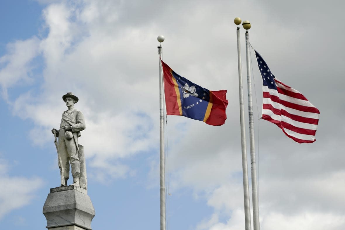 The Mississippi state and U.S. flags fly near the Rankin County confederate Monument in the downtown square of Brandon, Miss., on March 3, 2023. (AP Photo/Rogelio V. Solis, File)