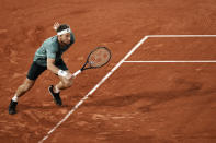 Norway's Casper Ruud runs to play a shot against Croatia's Marin Cilic during their semifinal match at the French Open tennis tournament in Roland Garros stadium in Paris, France, Friday, June 3, 2022. (AP Photo/Thibault Camus)
