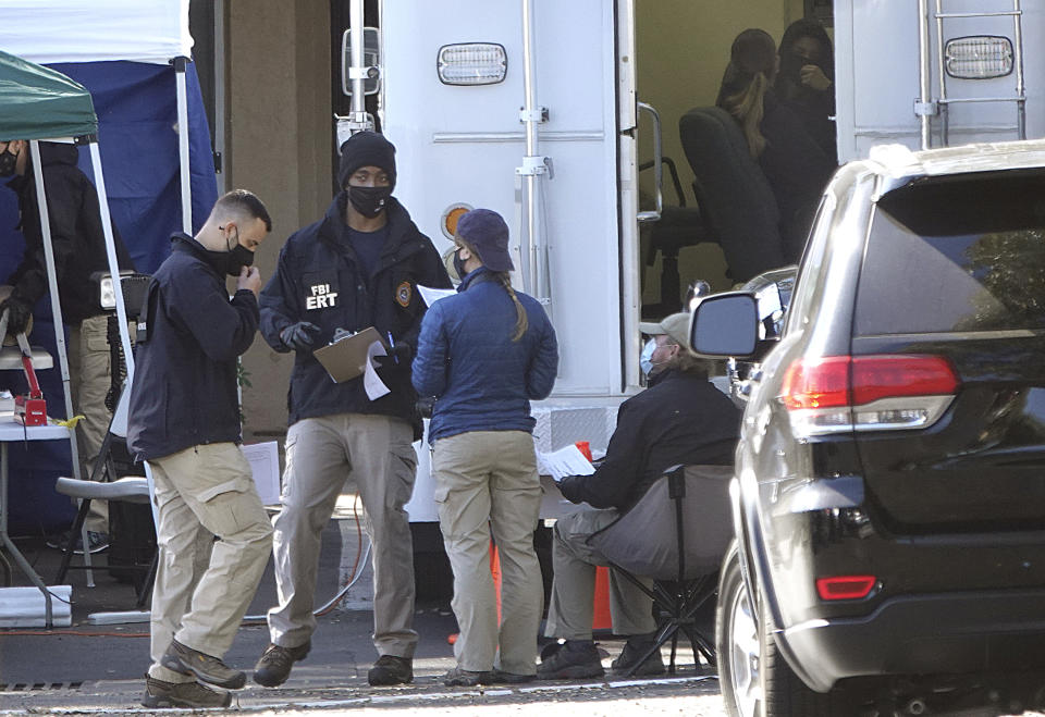 Members of the FBI Emergency Response Team continue to gather evidence at the Water's Edge apartments, Thursday, Feb. 4, 2021, in Sunrise, Fla. The complex was the scene of a shootout Monday which took the lives of two agents who were serving a warrant. (Joe Cavaretta/South Florida Sun-Sentinel via AP)