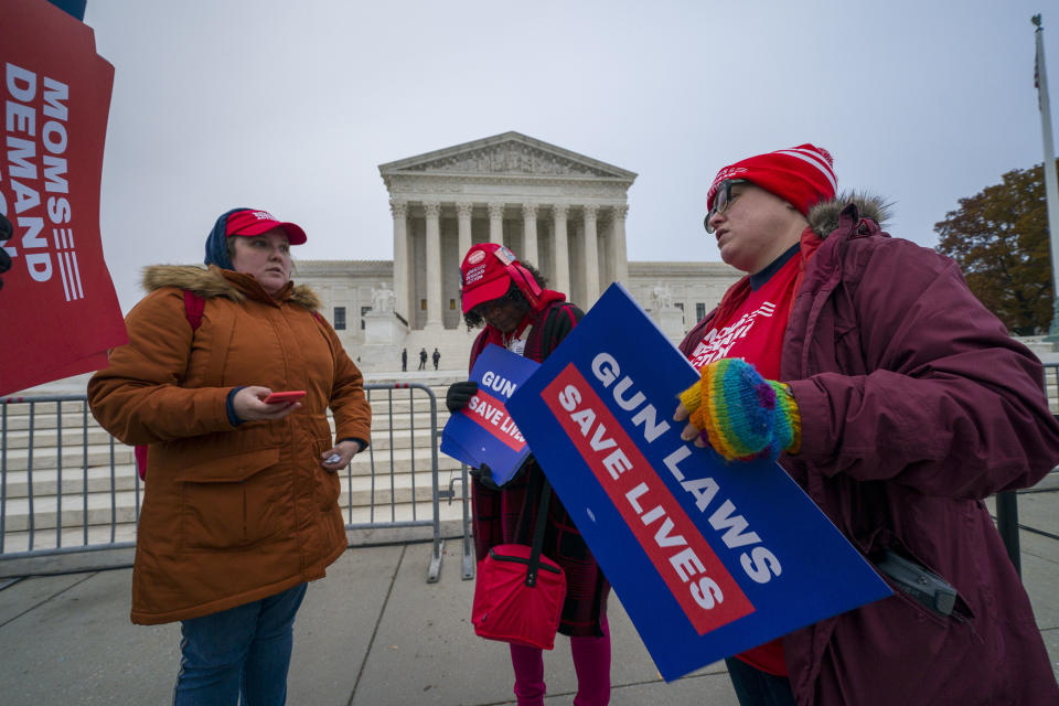 Gun control activists gather outside the Supreme Court on Dec. 2. 