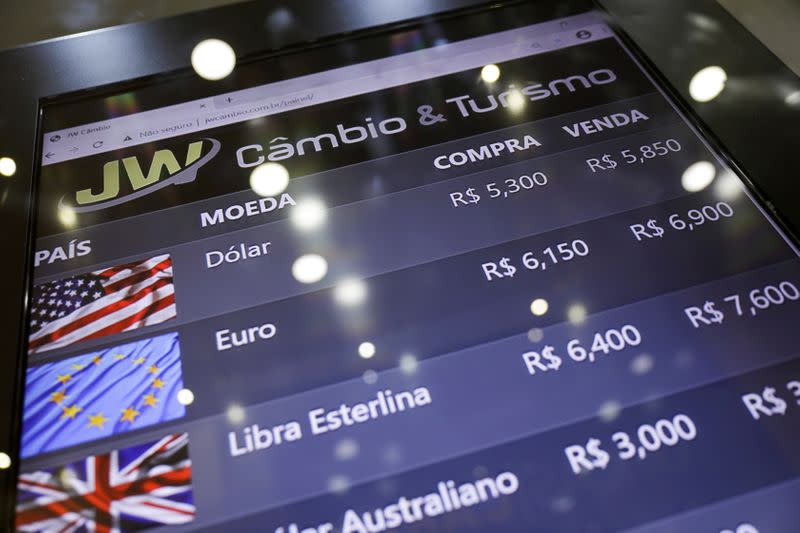 FILE PHOTO: An electronic board shows currency exchange rates in Rio de Janeiro