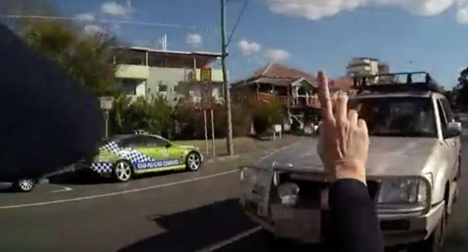 A driver has been filmed reversing into a car behind him after being asked by a Queensland Police officer to pull over in Brisbane’s suburb of Spring Hill. Source: Queensland Police