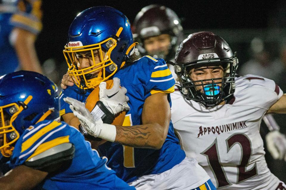 Sussex Central sophomore William Harmon (7) runs the ball as Appoquinimink sophomore Zachary Landry (12) grabs hold of him for a takedown attempt during the DIAA Class 3A football playoffs at Sussex Central in Georgetown, Friday, Nov. 17, 2023. Sussex Central won 28-7.