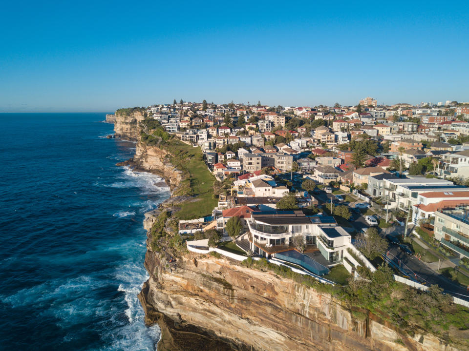 Aerial view of residential area across rock cliff area in Sydney coastline. (Source: Getty)