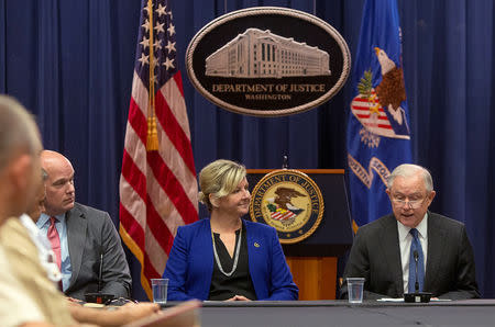 FILE PHOTO: Chief of Staff to the Attorney General Matthew Whitaker (L) looks past Kristi Johnson of the FBI to U.S. Attorney General Jeff Sessions as they participate in a roundtable discussion with foreign liaison officers at the Justice Department in Washington, U.S., August 29, 2018. REUTERS/Allison Shelley/File Photo