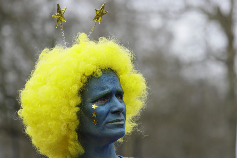 A demonstrator waits for the start of a Peoples Vote anti-Brexit march in London, Saturday, March 23, 2019. The march, organized by the People's Vote campaign is calling for a final vote on any proposed Brexit deal. This week the EU has granted Britain's Prime Minister Theresa May a delay to the Brexit process. (AP Photo/Kirsty Wigglesworth)