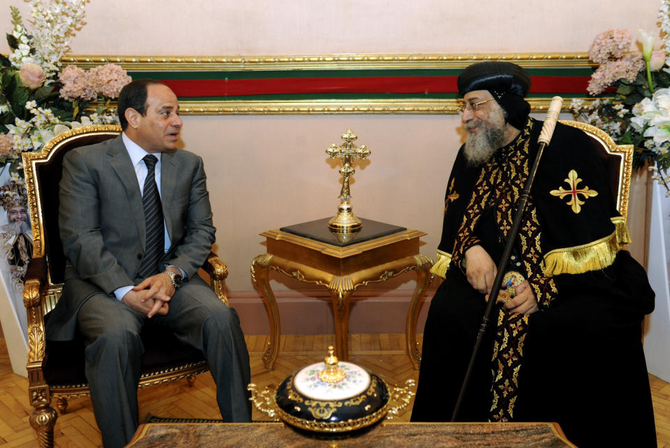 Egypt's former military chief Abdel-Fattah el-Sissi, left, meets with Coptic Pope Tawadros II at Cairo’s St. Mark’s Cathedral, seat of the Coptic Orthodox Pope, in Cairo, Egypt, Saturday, April 19, 2014. El-Sissi on Monday took the final formal step to run in next month's presidential election, submitting to the election commission eight times the number of signatures required. He is widely expected to win. (AP Photo/Girgis Mahboub, Office of the Coptic Pope)