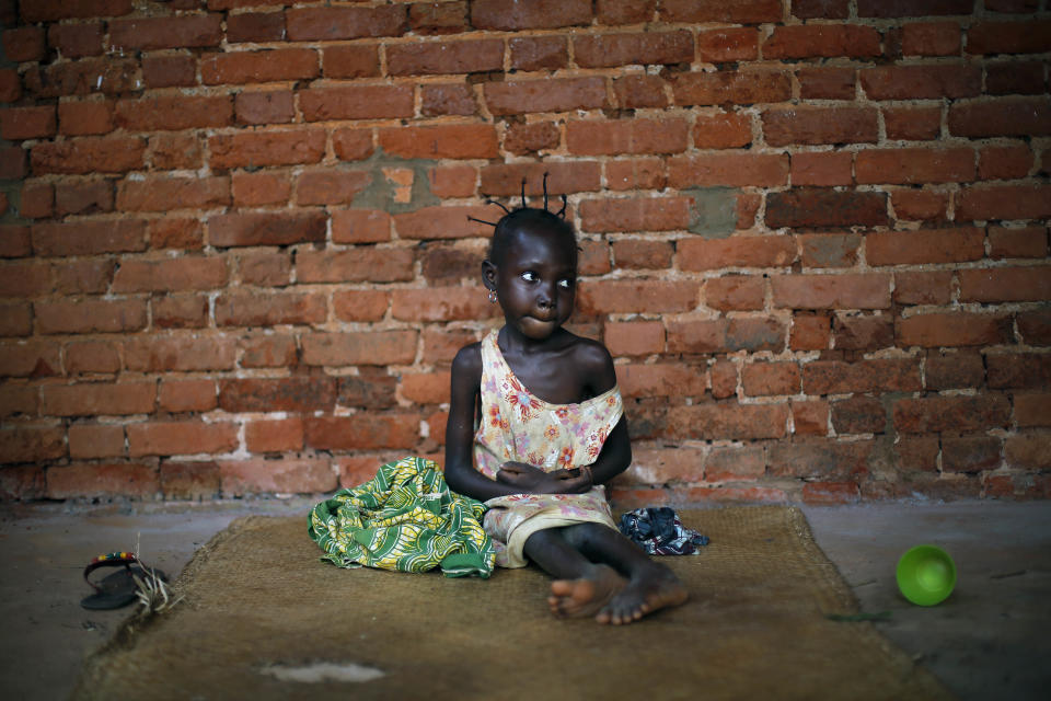 Amandine, 7, who found refuge in the Mbaiki cathedral, in Mbaiki, some 120kms (75 miles) south west of bangui, Central African Republic, sits on the ground, Sunday, Jan. 26, 2014. Amandine, who lost both parents five years ago, cannot speak nor walk. She has been in the care of a neighbor since the death of her parents and has been for the past three weeks living with dozens of others at the cathedral, fleeing sectarian violence that has wreaked the country. (AP Photo/Jerome Delay)