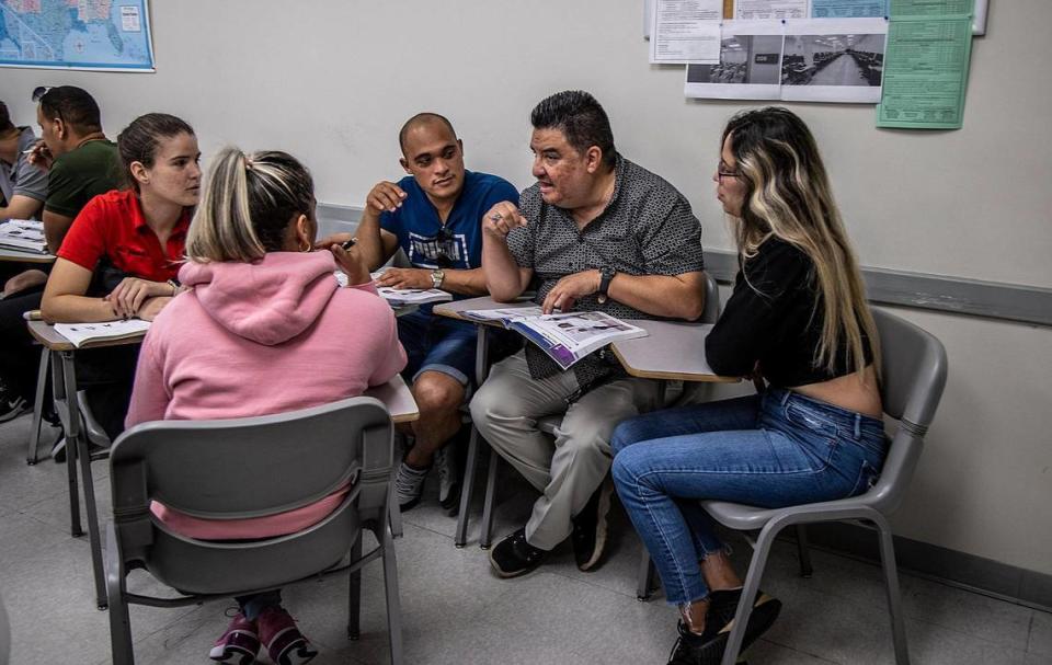 English teacher German A Silva (center) goes over some speech exercises with students (mostly Cubans),who recently arrived in Miami and are studying English at the Miami Dade College Revest Program building in Hialeah, on Thursday March16, 2023.