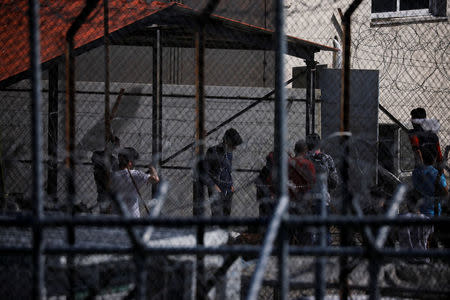 Refugees and migrants who crossed the Evros river, the natural border between Greece and Turkey, are seen at a first reception centre at the village of Fylakio, Greece, May 1, 2018. REUTERS/Alkis Konstantinidis