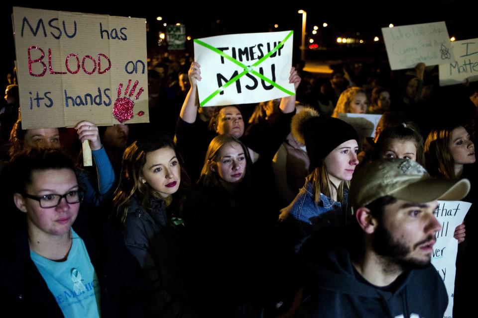 Michigan State University students march to the steps of the campus administration building on Friday, Jan. 26, 2018, to protest the school's handling of the sexual abuse allegations against former campus doctor Larry Nassar.