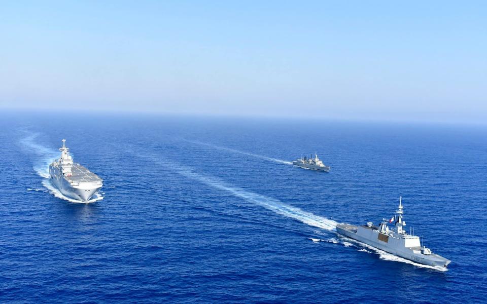 A French helicopter carrier is escorted by Greek and French warships in the eastern Mediterranean - Greek National Defence via AP)