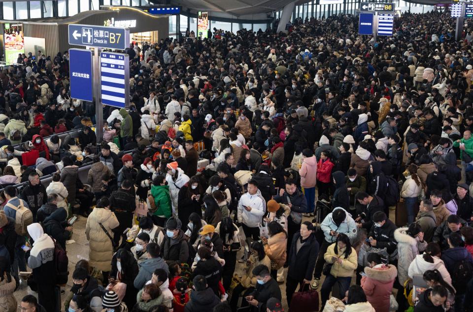People waiting in a departure hall at Wuhan Railway Station after some trains were suspended due to freezing rain and snow.