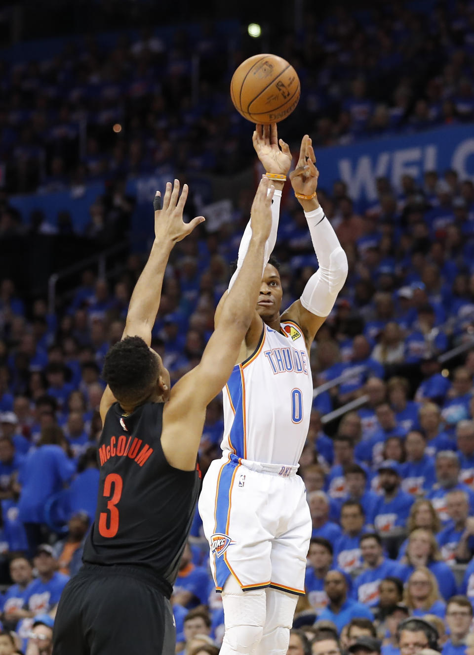 Oklahoma City Thunder guard Russell Westbrook (0) shoots a three point basket as Portland Trail Blazers guard CJ McCollum (3) defends in the first half of Game 4 of an NBA basketball first-round playoff series Sunday, April 21, 2019, in Oklahoma City. (AP Photo/Alonzo Adams)