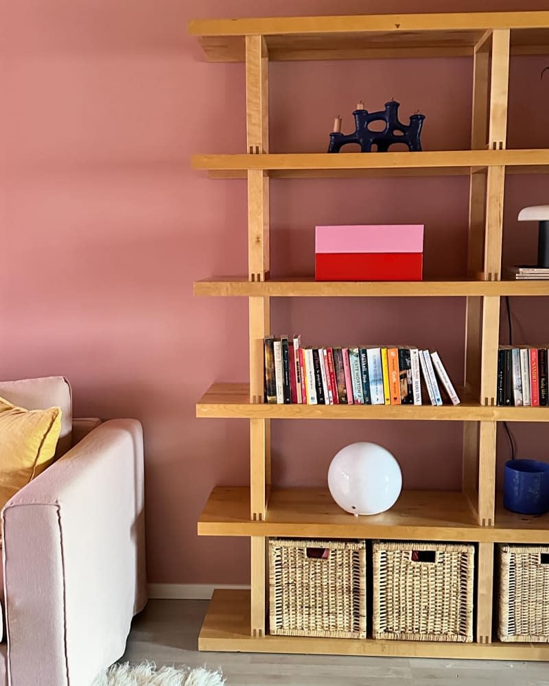 Books arranged on a wooden shelf.