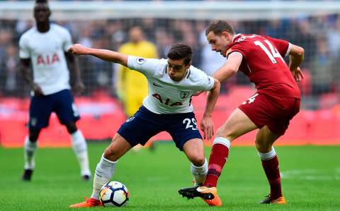 Harry Winks vies with Liverpool's English midfielder Jordan Henderson  - Credit: GLYN KIRK/AFP