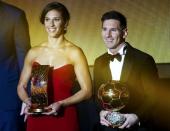 Houston Dash's Carli Lloyd of the U.S. and FC Barcelona's Lionel Messi of Argentina hold their FIFA Ballon d'Or 2015 awards for the world player of the year at a ceremony in Zurich, Switzerland, January 11, 2016. . REUTERS/Ruben Sprich