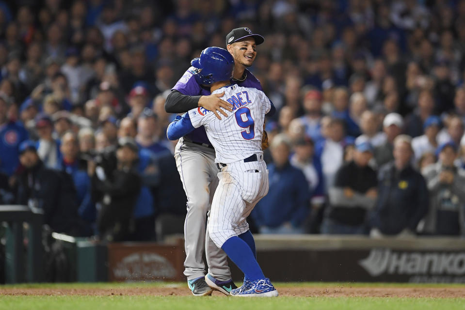 Javier Baez #9 of the Chicago Cubs hugs Nolan Arenado #28 of the Colorado Rockies in the eleventh inning during the National League Wild Card Game at Wrigley Field on October 2, 2018 in Chicago, Illinois. (Photo by Stacy Revere/Getty Images)