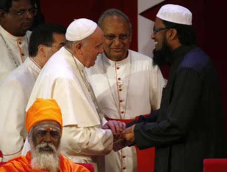 Pope Francis shakes hands with Muslim Maulavi Ash-Sheikh M.F. M. Fazil (R) during the Interreligious Encounter at the Bmich in Colombo January 13, 2015. REUTERS/ Stefano Rellandini