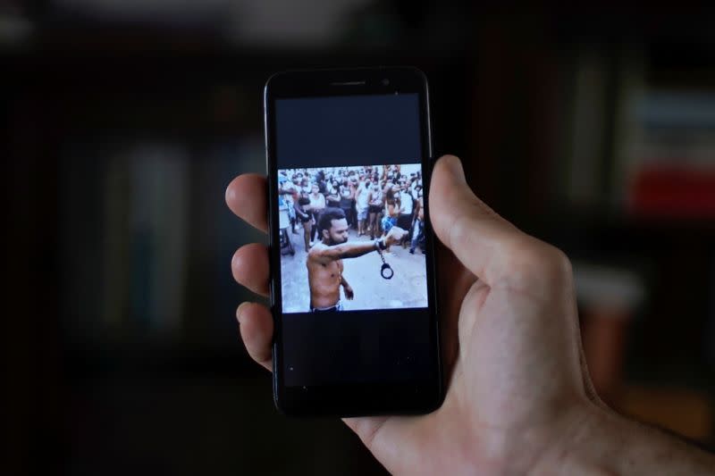 Image displayed in social media of rapper Maykel Osorbo with handcuffs clamped around one wrist, in Havana