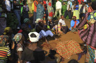 In this photo taken Friday, Oct 5, 2018, family members and onlookers mourn over the bodies of civilian killed by The Allied Democratic Forces rebels in Beni, Eastern Congo. Congo’ military said Sunday Oct. 21, 2018, that rebels attacked an Ebola treatment centre in Beni, leaving over a dozen civilians dead and abducted about a dozen children, which could force crucial virus containment efforts to be suspended in the area. (AP Photo/Al-hadji Kudra Maliro)