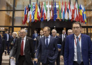 From left, European Commission President Jean-Claude Juncker, Irish Prime Minister Leo Varadkar, European Council President Donald Tusk and European Union chief Brexit negotiator Michel Barnier walk to a media conference at an EU summit in Brussels, Thursday, Oct. 17, 2019. Britain and the European Union reached a new tentative Brexit deal on Thursday, hoping to finally escape the acrimony, divisions and frustration of their three-year divorce battle. (AP Photo/Virginia Mayo)