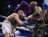 <p>Floyd Mayweather Jr. hits Conor McGregor in a super welterweight boxing match Saturday, Aug. 26, 2017, in Las Vegas. (AP Photo/Isaac Brekken) </p>