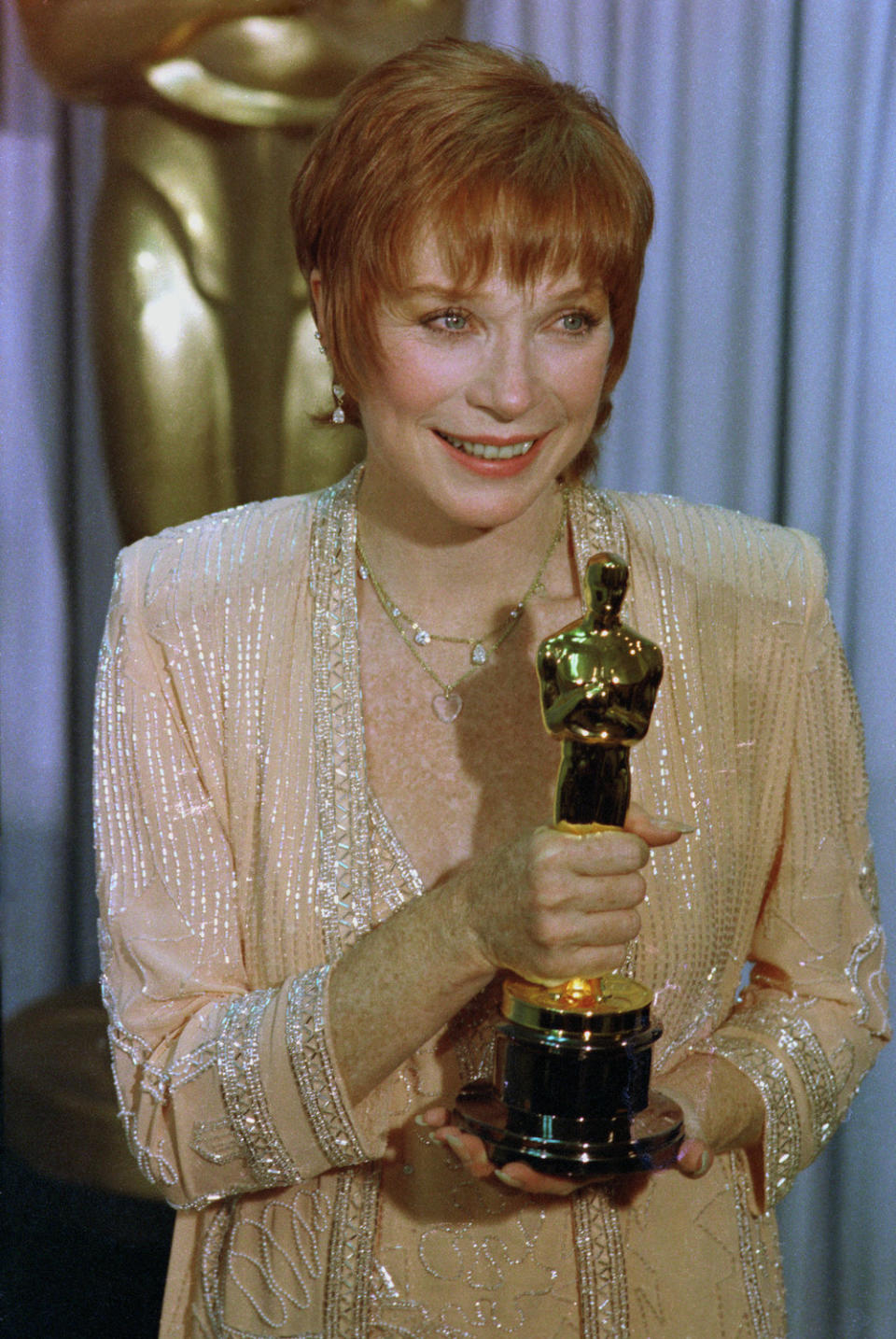 MacLaine posing with her Oscar backstage