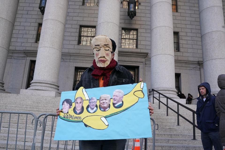 A man holds a sign outside the Thurgood Marshall United States Courthouse as the trial of Ghislaine Maxwell begins in New York (AFP via Getty Images)