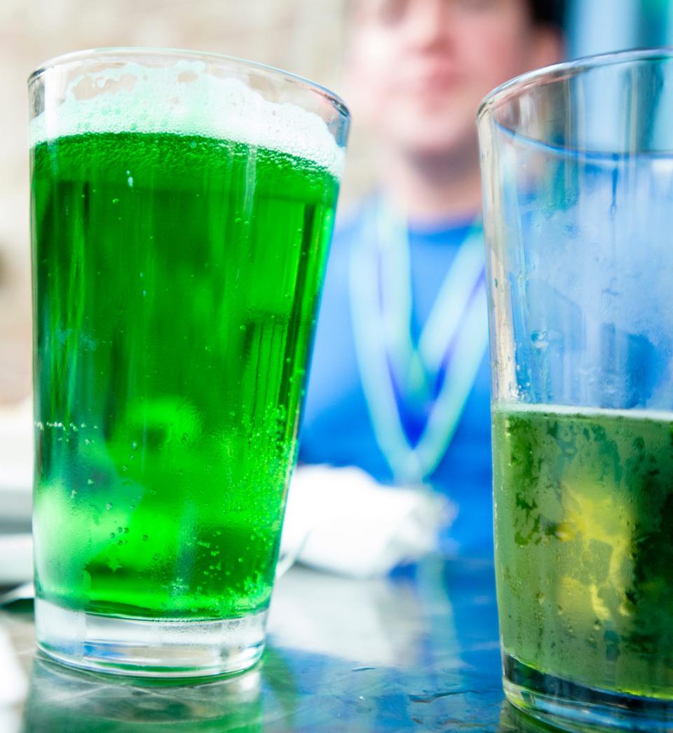 Patrons drink green beer during a pre-St. Patrick's Day celebration at Irish Bred Pub in Montgomery, Ala.