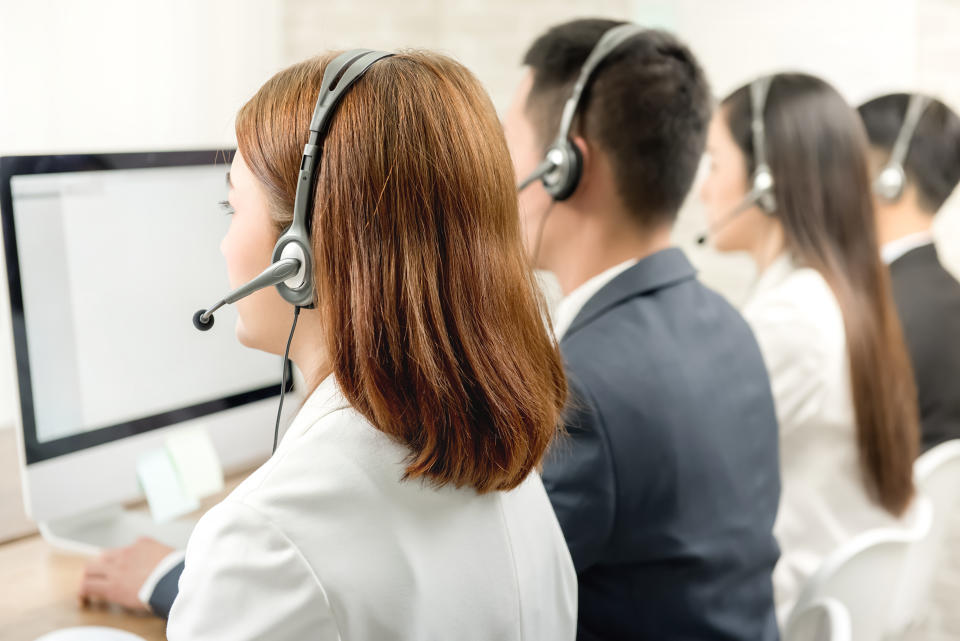 Back view of Asian telemarketing customer service agent team, call center job concept