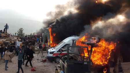 A smoke rises from vehicles after protesters stormed a Turkish military camp near Dohuk, Iraq January 26, 2019. REUTERS/Stringer