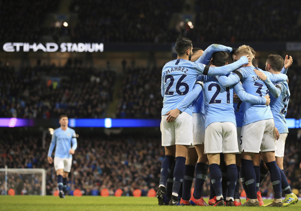 Manchester City's Raheem Sterling celebrates with teammates after scoring his side's sixth goal during the English Premier League soccer match between Manchester City and Chelsea at Etihad stadium in Manchester, England, Sunday, Feb. 10, 2019. (AP Photo/Jon Super)