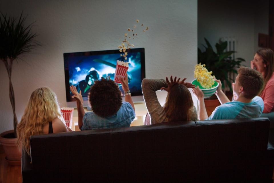 friend group on couch watching scary movie