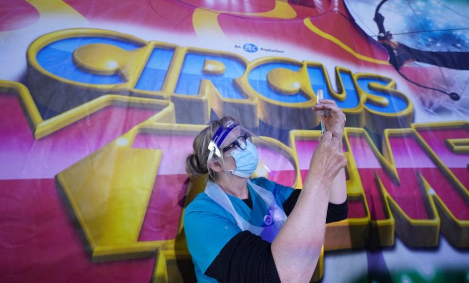 Dr Lisa Pickles, 57, clinical lead for the Calderdale vaccination program prepares a syringe at a pop-up Covid-19 vaccination clinic in the marquee of Circus Extreme in Halifax (Owen Humphreys/PA) (PA Wire)