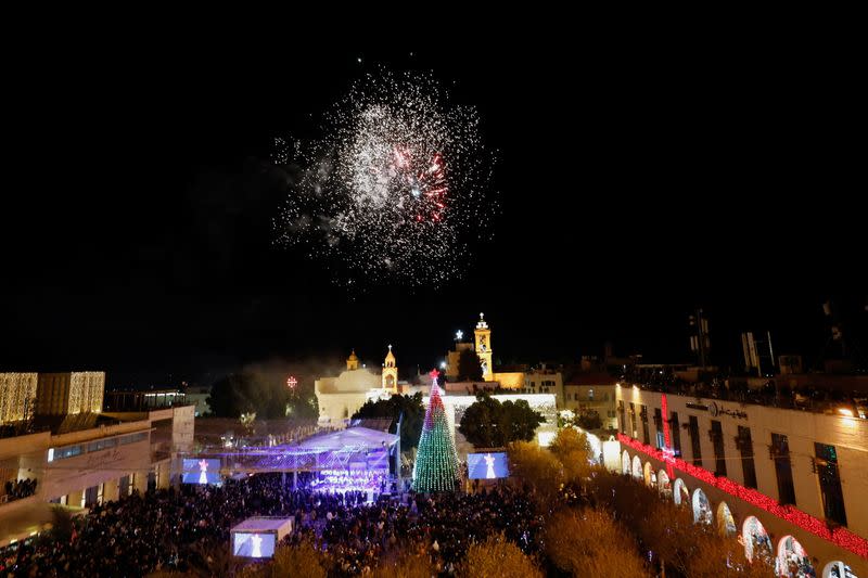 Palestinians light a Christmas tree in Bethlehem