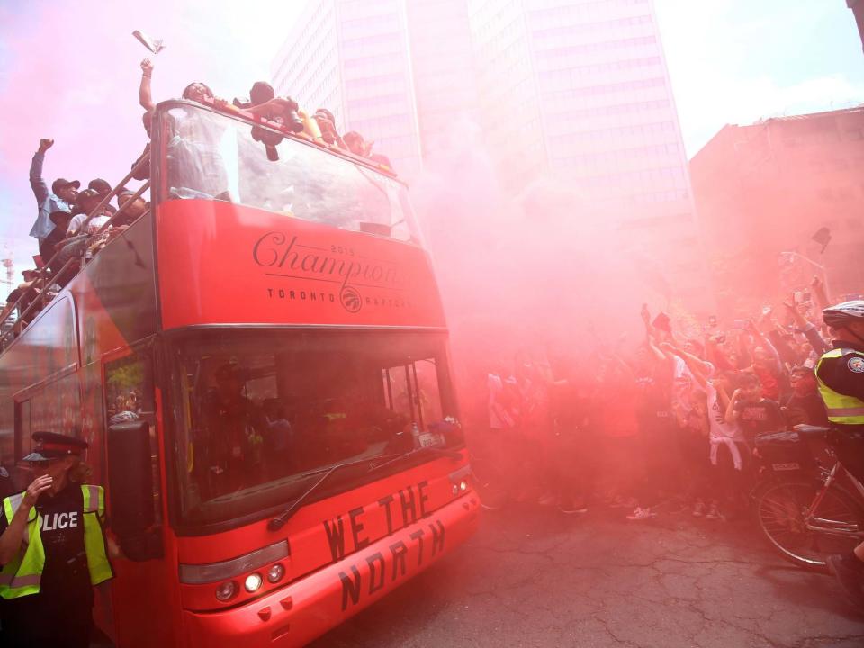 Revelry has turned to chaos after four people were injured in a shooting at a celebration in honour of the Toronto Raptors's historic NBA championship win.The shooting in the Canadian city sparked a panic among those partying near Nathan Phillips Square, where a reported millions of people had gathered in and around to mark the first franchise victory for the Canadian team.Three suspects, and two firearms, were in police custody as Toronto police began their investigation, according to a tweet from the Toronto Police Department.Video and images of the scene showed fans dressed in red fleeing, without a clear indicator of what exactly was happening.According to Canada's Global News, Toronto police officers were called to the scene just before 4pm local time.A tweet from Toronto police stated that four victims had been identified, two of which had serious, but not life-threatening injuries.The Toronto Raptors did not immediately respond to the reports, but video posted onto the team's Twitter account showed the crowds packed with supporters on a bright day with clear skies.The Raptors won their first franchise NBA championship in history late last week, with a 114-110 victory over the Golden State Warriors in Game 6 of the NBA Finals.The Toronto Police Department did not immediately identify a motive behind the shooting in Toronto.