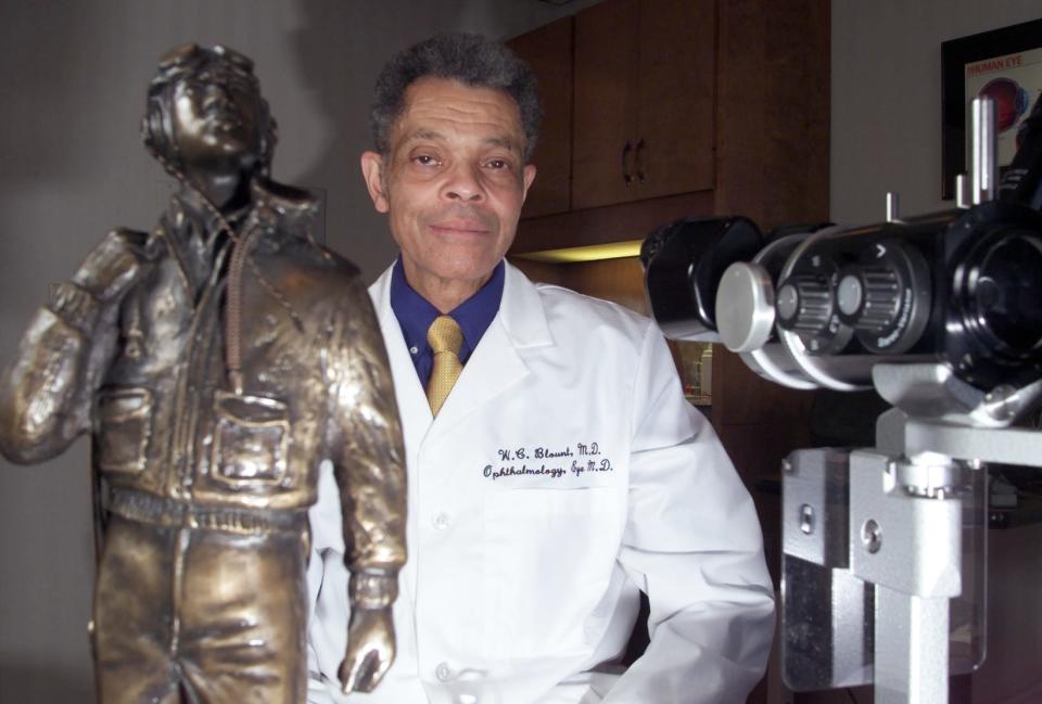 Dr. Wilbur Blount poses with one of the 99 Tuskegee Airman statues in his medical office in this file photo.  An ophthalmologist who specialized in diseases and surgery of the retina and vitreous, he was awarded the Noel F. Parrish award by the Tuskegee Airman.