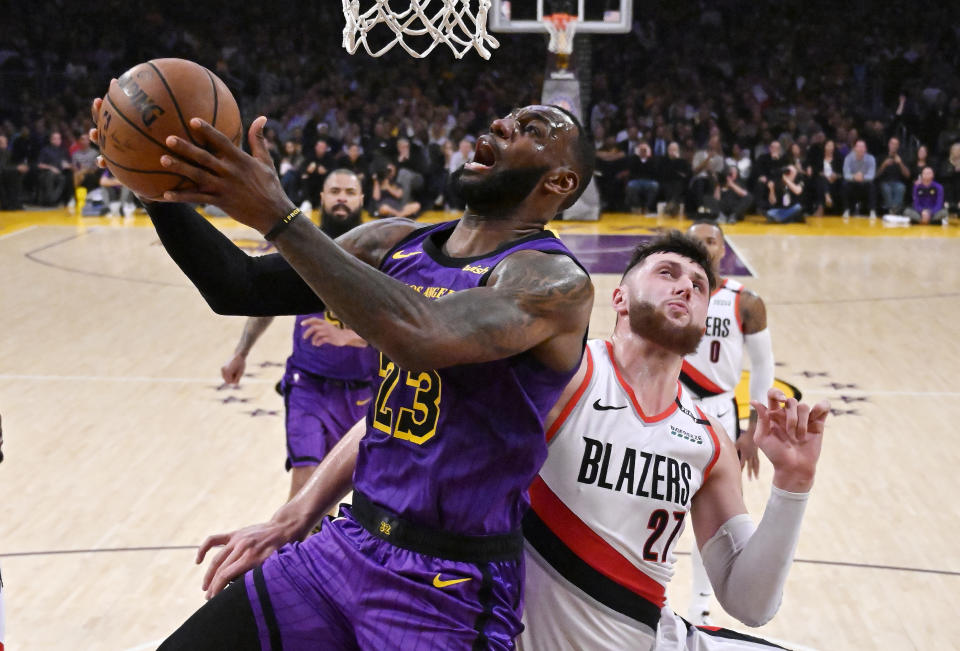 Los Angeles Lakers forward LeBron James shoots as Portland Trail Blazers center Jusuf Nurkic defends during the second half of an NBA basketball game Wednesday, Nov. 14, 2018, in Los Angeles. The Lakers won 126-117. (AP Photo/Mark J. Terrill)