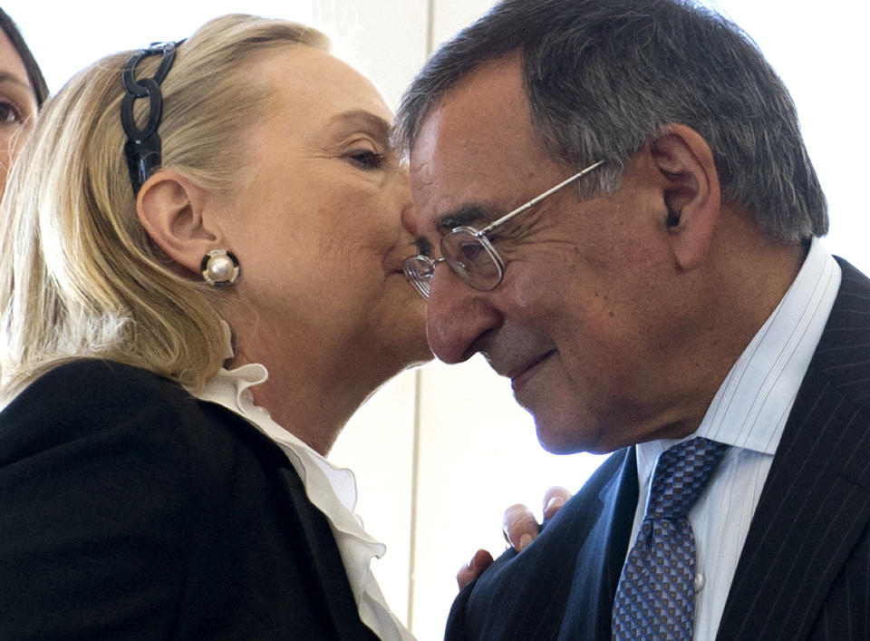 U.S. Secretary of State Hillary Clinton whispers in the ear of U.S. Secretary of Defense Leon Panetta during a reception hosted by Western Australia Premier Colin Barnett at the Indiana Teahouse at Cottesloe Beach near Perth Wednesday, Nov. 14, 2012. (AP Photo/Saul Loeb, Pool)