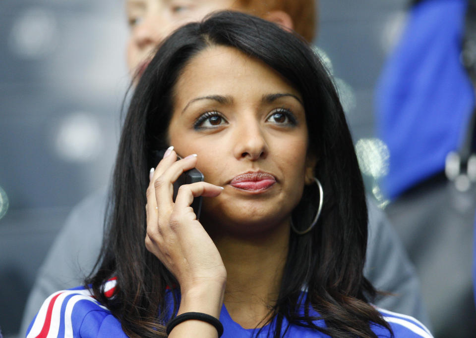 The wife of French defender Eric Abidal speaks on the phone before the Euro 2008 Championships Group C football match Netherlands vs. France on June 13, 2008 at  the Stade de Suisse Wankdorf in Bern, Switzerland.   AFP PHOTO / VALERY HACHE      -- MOBILE SERVICES OUT --  (Photo credit should read VALERY HACHE/AFP via Getty Images)