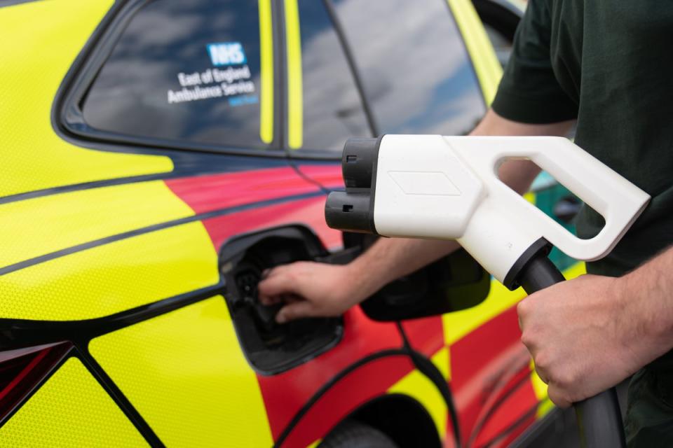 A paramedic charges one of the new electric rapid response vehicles (Joe Giddens/ PA) (PA Wire)