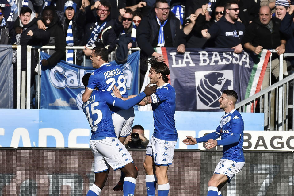 Brescia forward Mario Balotelli, left, is embraced by teammate Romulo after scoring his side's first goal during the Italian Series A soccer match between Brescia and Lazio at the Mario Rigamonti stadium in Brescia, Italy, Sunday, Jan. 5, 2020. (Gianluca Checchi/LaPresse via AP)