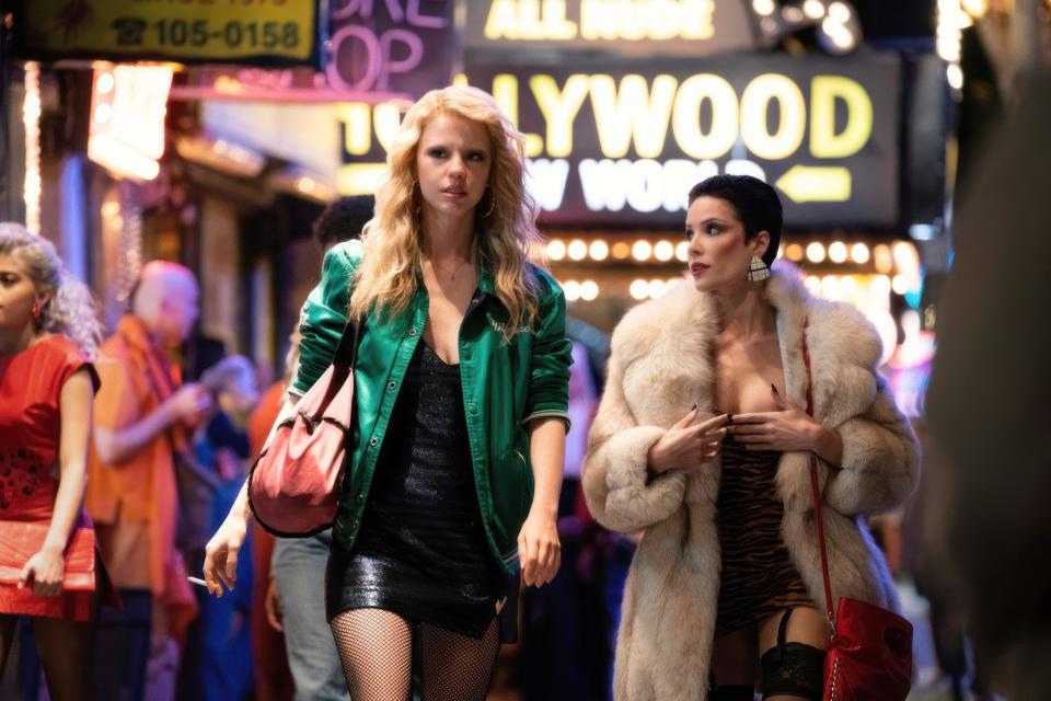 Mia Goth and Halsey  waling down a busy city sidewalk in "MaXXXine"