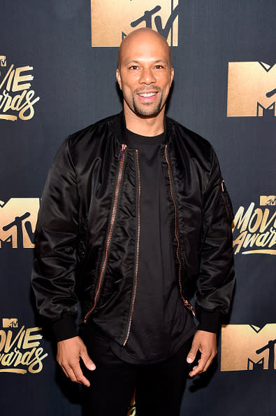 Common in a silk bomber and black T-shirt 