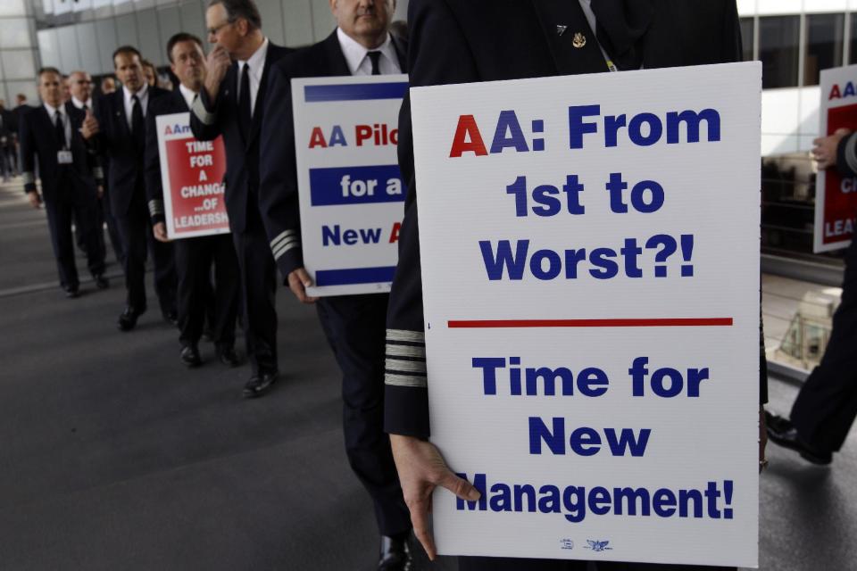 FILE-In this Thursday, Sept. 20, 2012, file photo, over 200 American Airline pilots march on a picket line at O'Hare International in Chicago, Ill. Just weeks ago, American Airlines was working its way through bankruptcy court, on schedule for one of the fastest turnarounds in aviation history, but then, domestic traffic fell by 7.1 percent in September from the same month a year earlier. No other major airline experienced a drop like that. (AP Photo/M. Spencer Green, FIle)