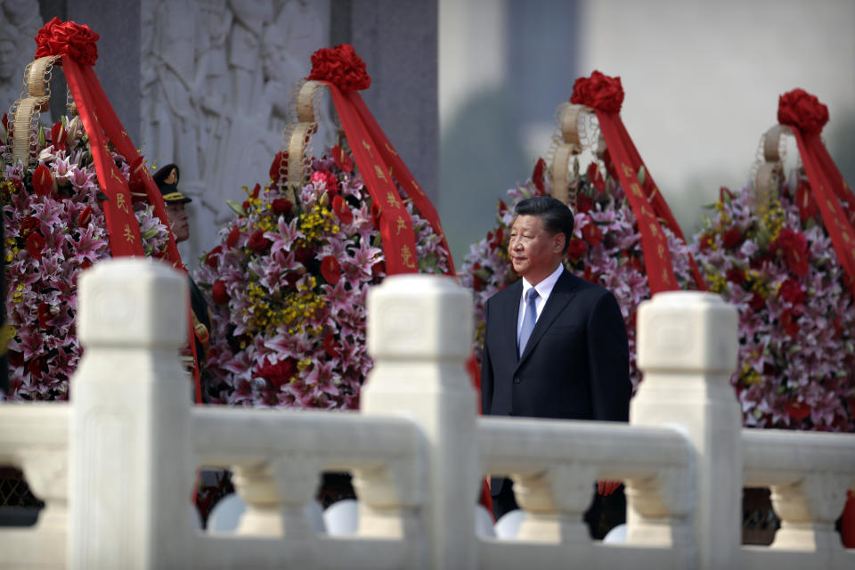 Chinese President Xi Jinping walks past floral wreaths at the Monument to the People's Heroes during a ceremony to mark Martyr's Day at Tiananmen Square in Beijing, Monday, Sept. 30, 2019. Xi led other top officials in paying respects to the founder of the communist state Mao Zedong ahead of a massive celebration of the People's Republic's 70th anniversary. (AP Photo/Mark Schiefelbein, Pool)
