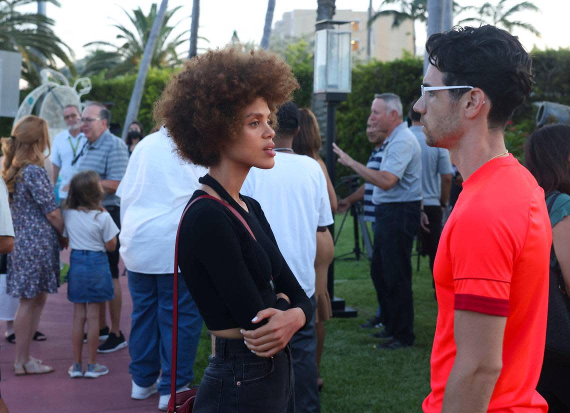 Greylin Quelliz, left, and Chris Afonso, both of whom were in the Towers the night of the collapse, talk after a ceremony to extinguish the symbolic flame in front of the Champlain Towers South site in Surfside on Wednesday, July 20, 2022. Wednesday marked one year since the last of the 98 victims of the collapse was recovered. ‘Never take life for granted. ... Appreciate the small things,’ said Afonso.