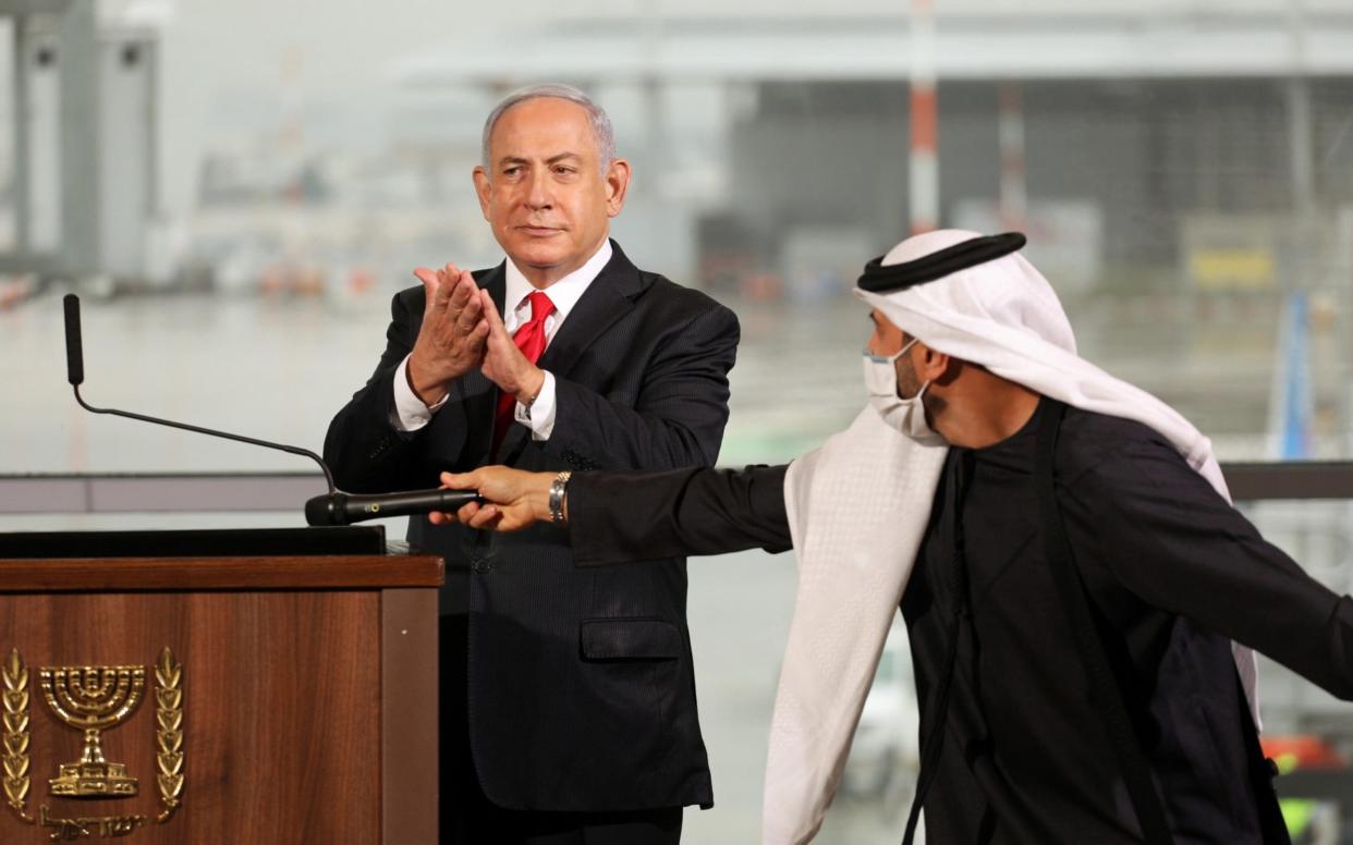 Israeli Prime Minister Benjamin Netanyahu gestures during a welcoming ceremony upon the landing of a United Arab Emirates airline flydubai flight at Tel Aviv - Pool/Reuters